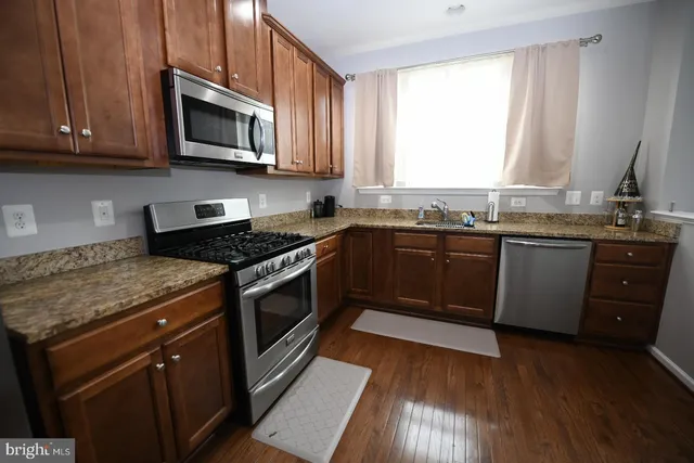 a kitchen with a stove a sink and a microwave