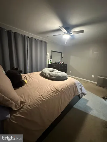 a bedroom with a bed lamp and a chandelier