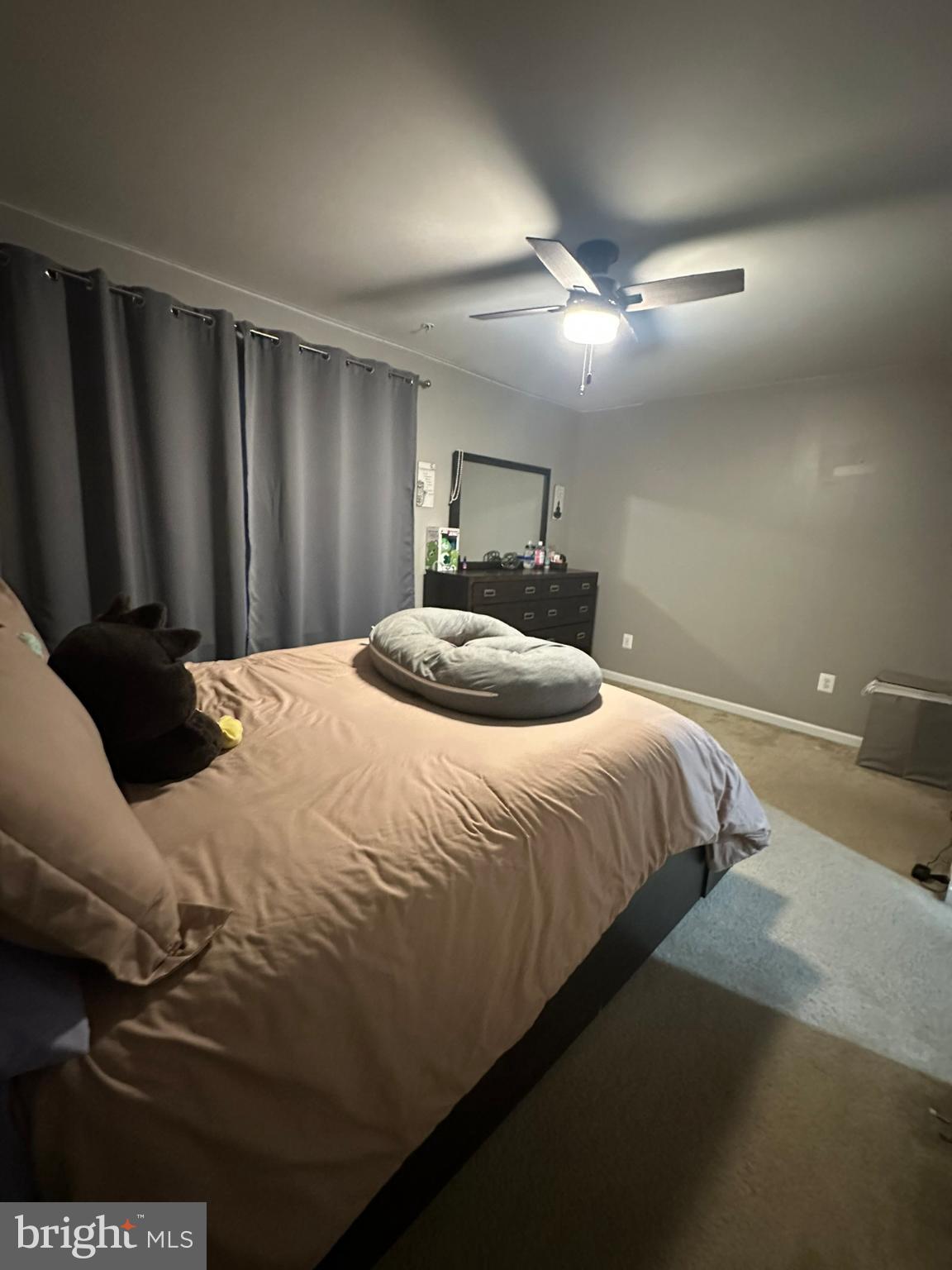 23171 Ambrosia Lane California, MD 20619 - Photo 10 of 18 a bedroom with a bed lamp and a chandelier