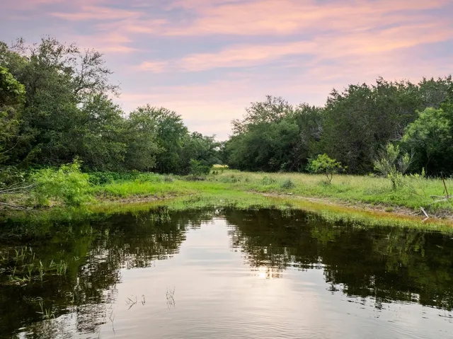 a view of a lake with a yard