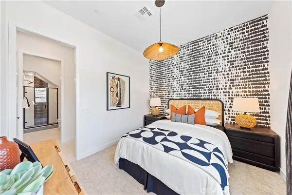 a bedroom with a bed and a night stand