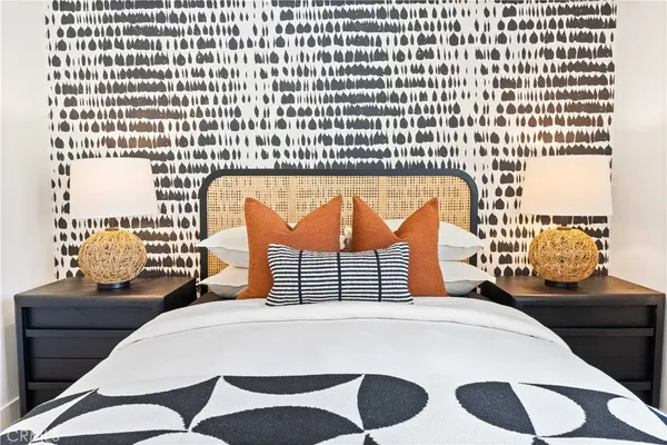 a bedroom with a bed and a night stand