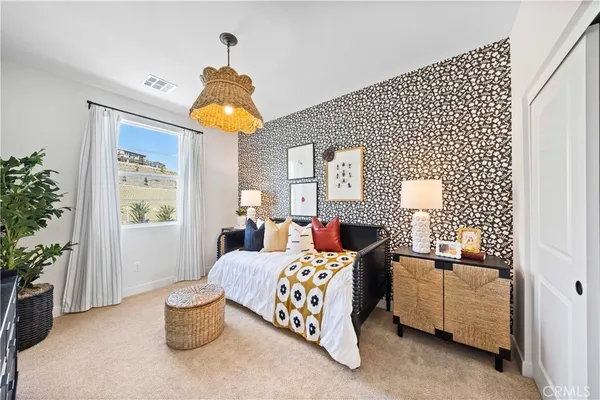 a bedroom with bed and window