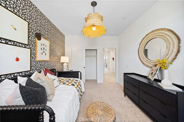 a bedroom with a bed and a chandelier