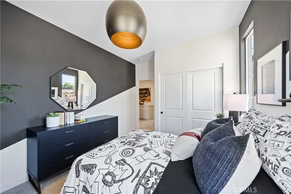 a bedroom with a bed and a chandelier