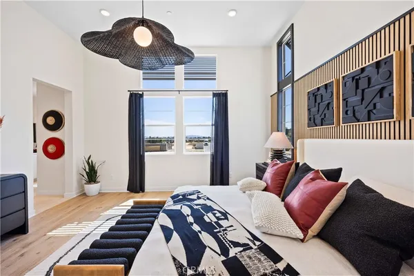 a bedroom with bed and wooden floor