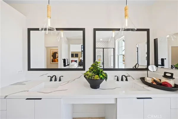 a bathroom with a double vanity sink and a mirror