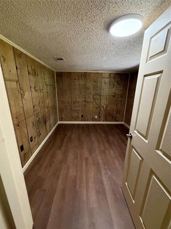 257 West Acres Road Gun Barrel City, TX 75156 - Photo 11 of 22 a view of an empty room with wooden floor and door