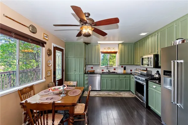 a kitchen with a sink dishwasher a refrigerator and a stove top oven
