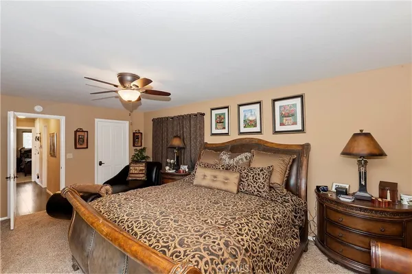 a bedroom with a bed and a large window with a flat tv screen