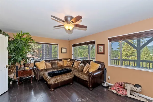 a living room with furniture a fireplace and a window