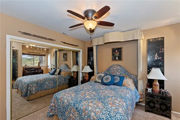 a living room with furniture a ceiling fan and a rug