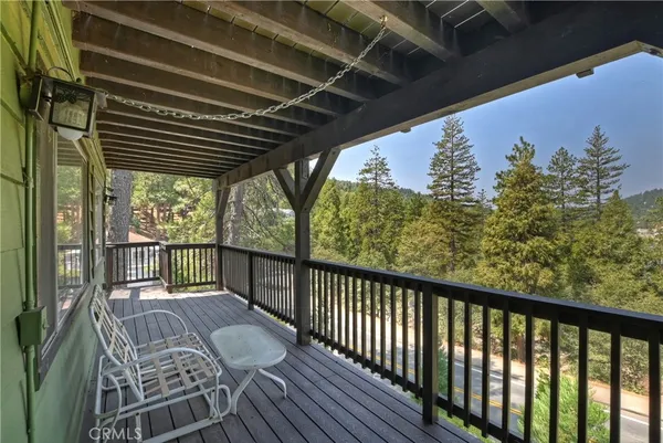 a view of a deck with a table and chairs