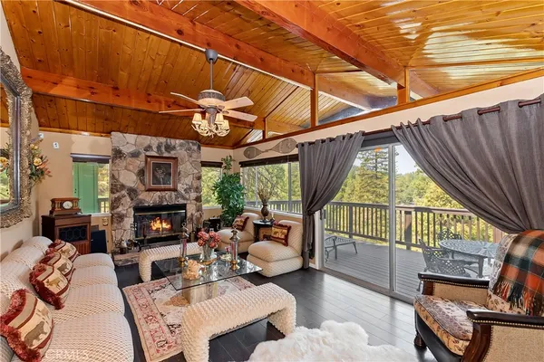 a living room with furniture a fireplace and a table
