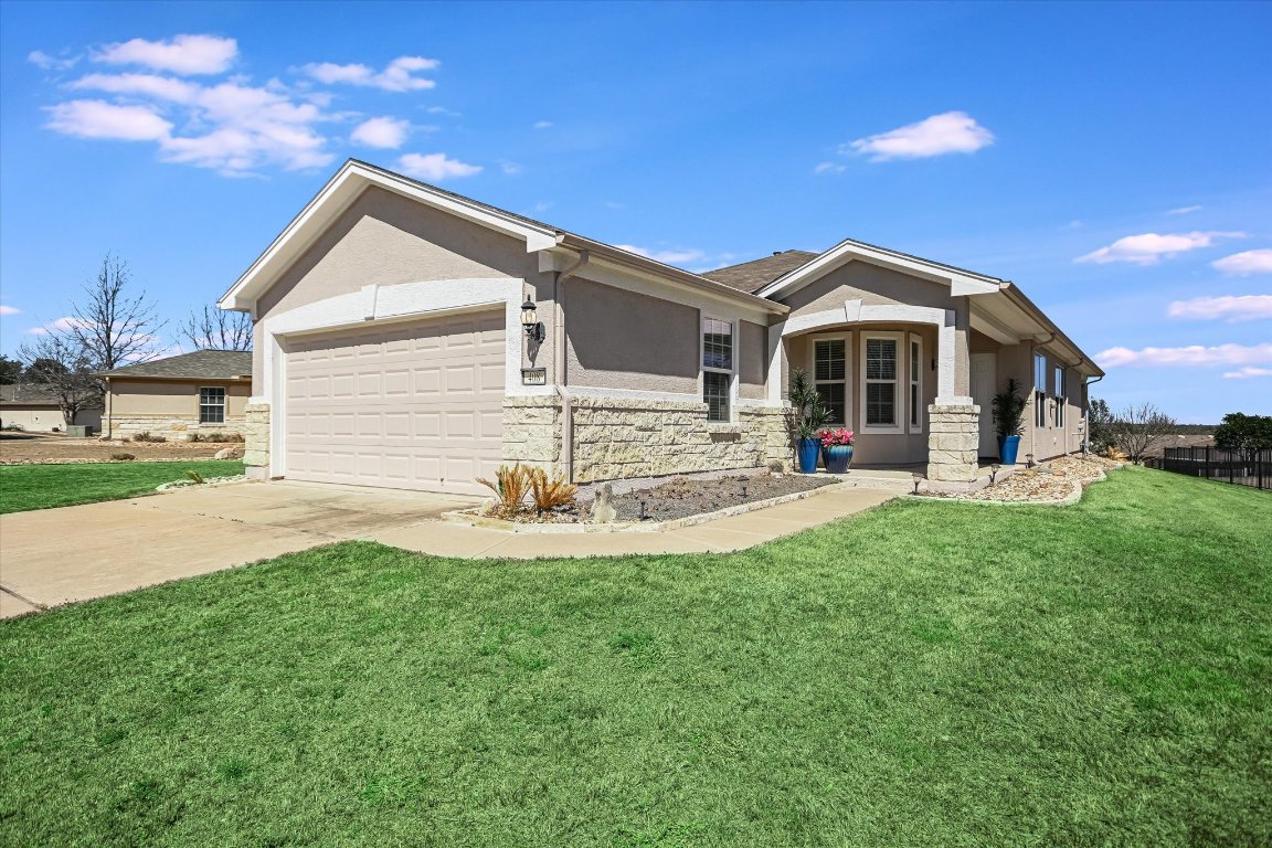 a view of a house with a yard and patio