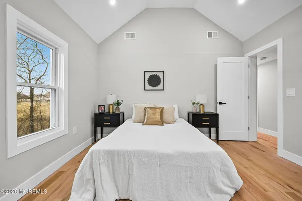 a bedroom with a bed and a window