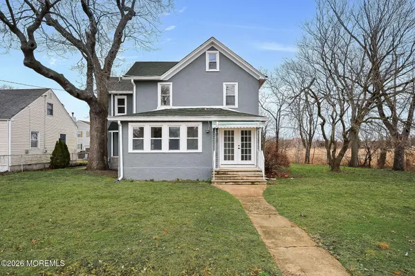 a front view of a house with a garden