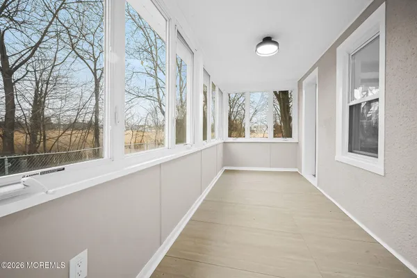 a view of an entryway with wooden floor and door