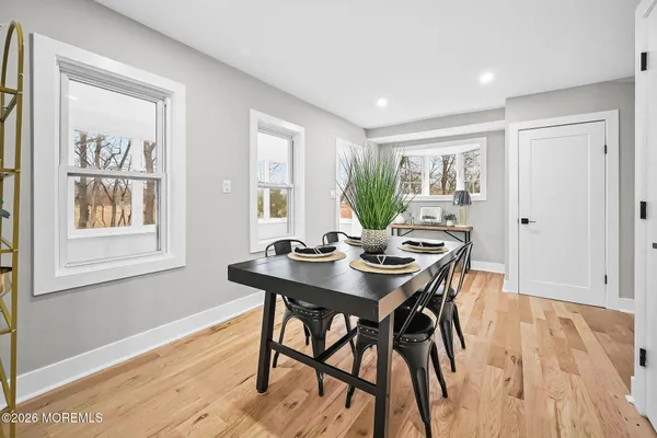 a view of a dining room with furniture and wooden floor