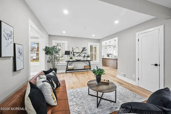 a living room with furniture and a potted plant