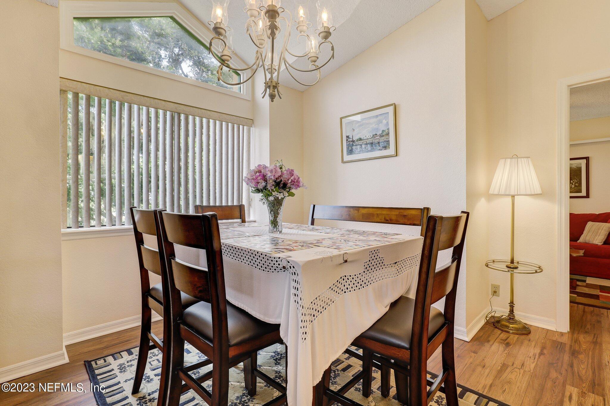 99 Broad River Place, Unit 1301 Welaka, FL 32193 - Photo 13 of 50 a view of a dining room with furniture and wooden floor