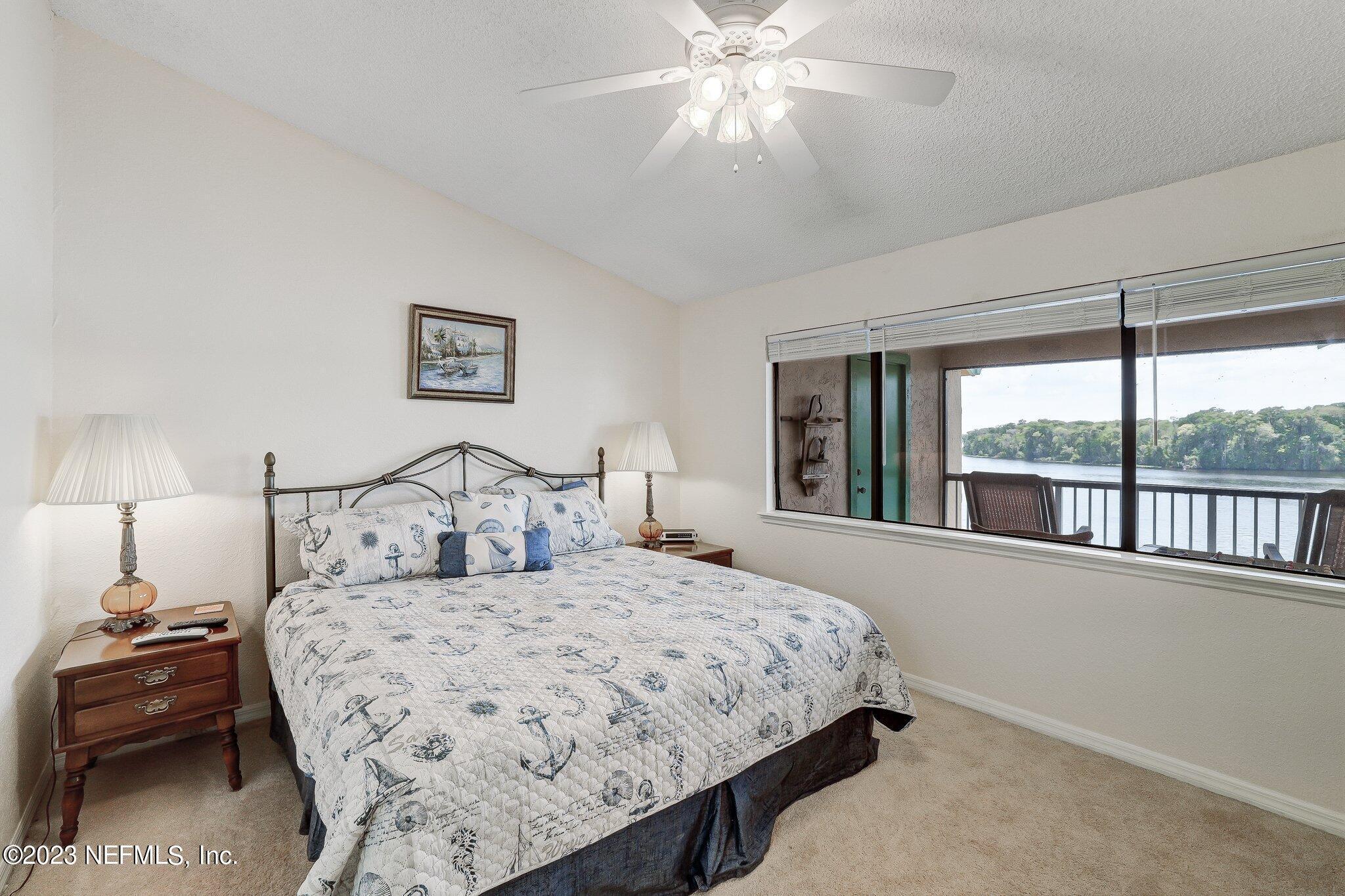 99 Broad River Place, Unit 1301 Welaka, FL 32193 - Photo 16 of 50 a bedroom with a large bed and a window