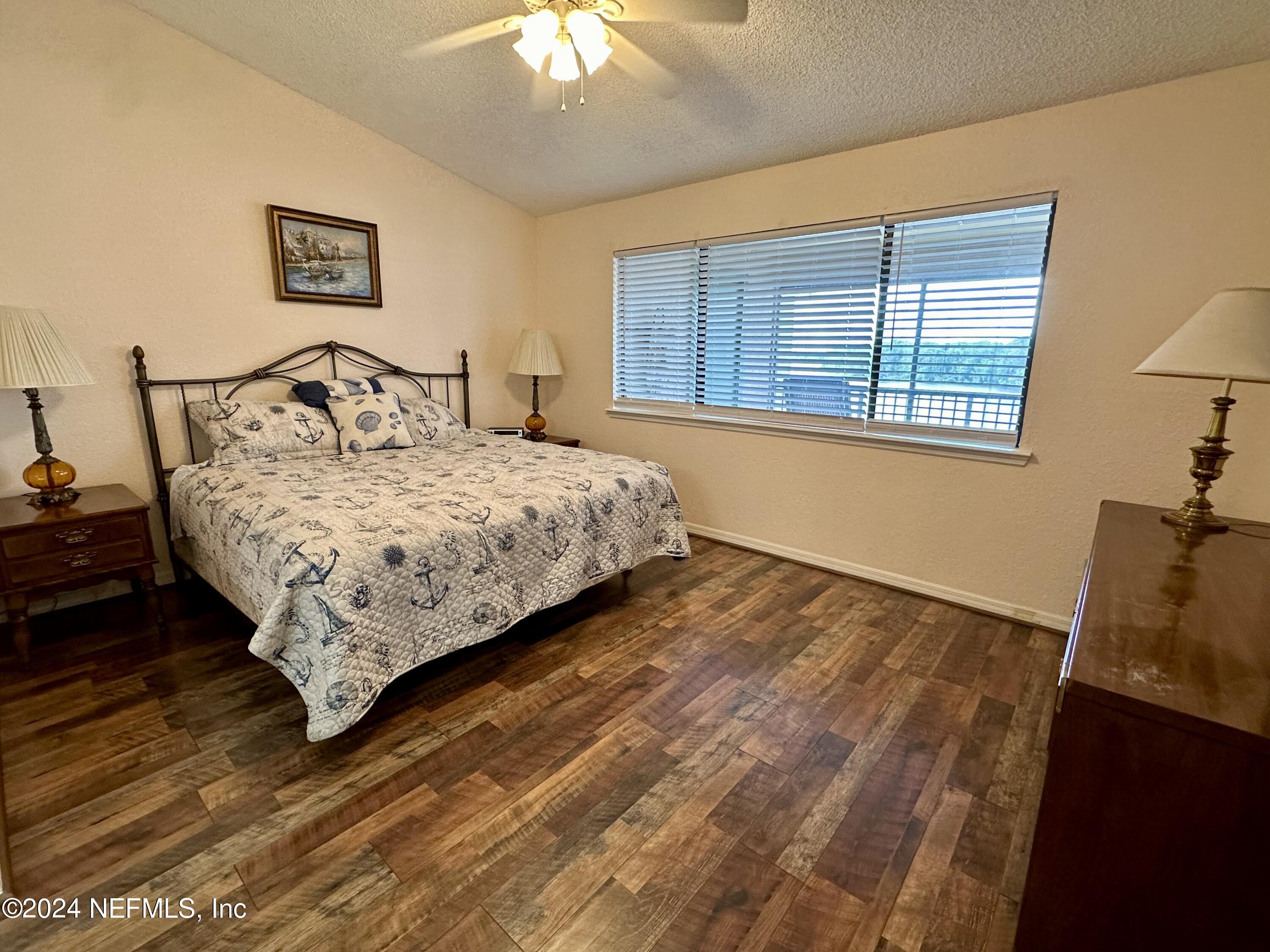 99 Broad River Place, Unit 1301 Welaka, FL 32193 - Photo 18 of 50 a bedroom with a bed and a window