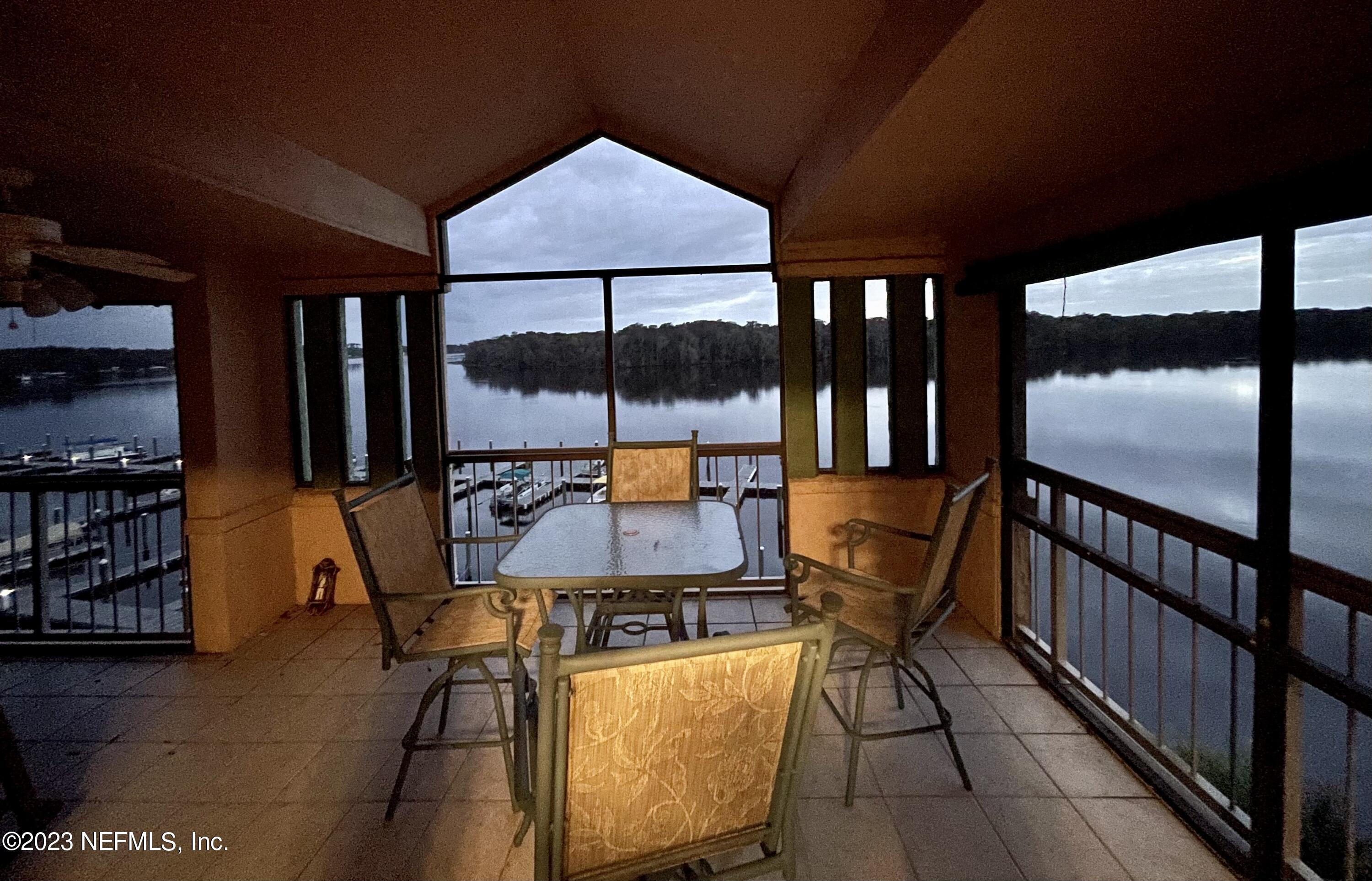 99 Broad River Place, Unit 1301 Welaka, FL 32193 - Photo 2 of 50 a balcony with table and chairs