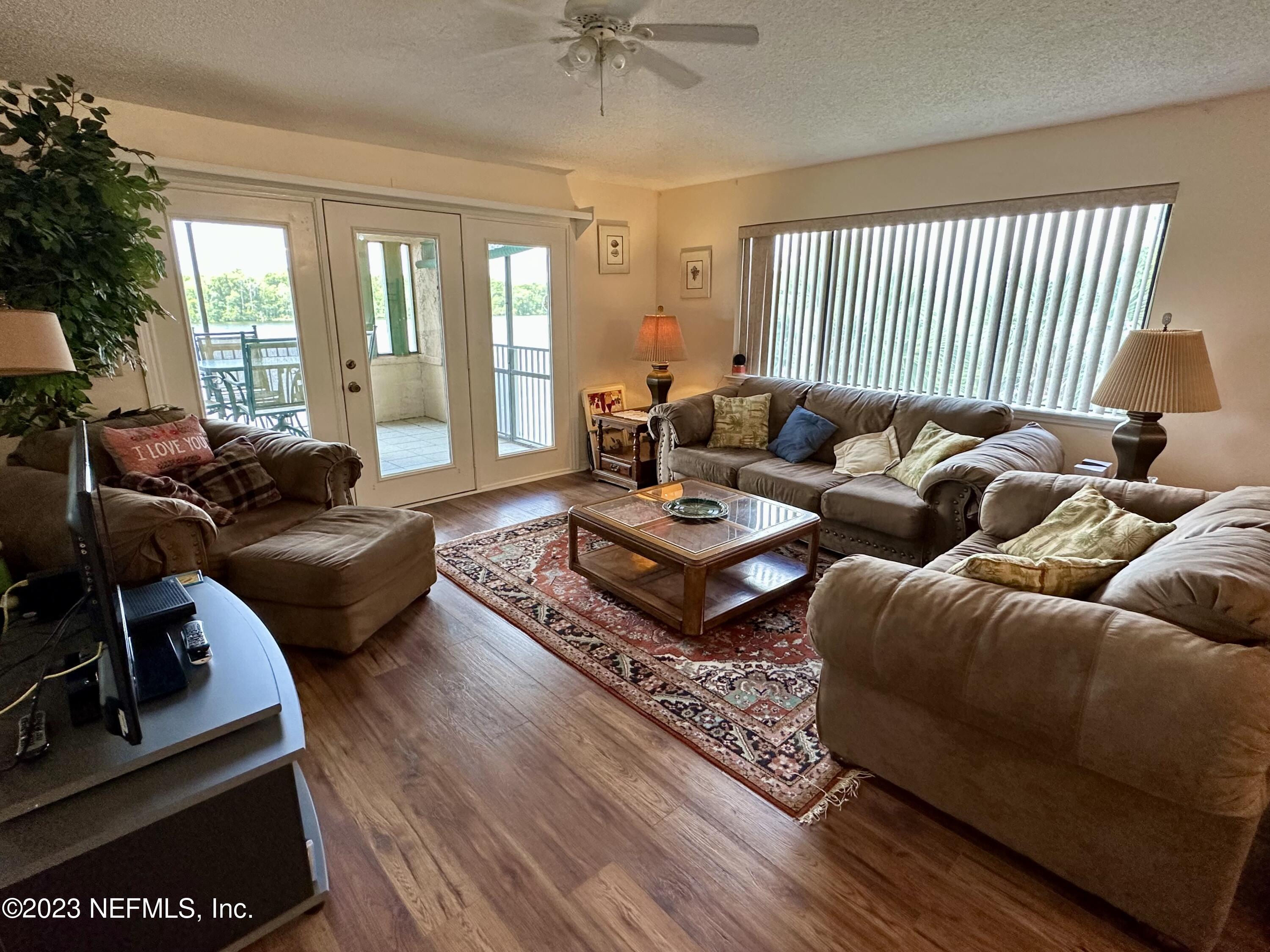 99 Broad River Place, Unit 1301 Welaka, FL 32193 - Photo 46 of 50 a living room with furniture rug and a large window