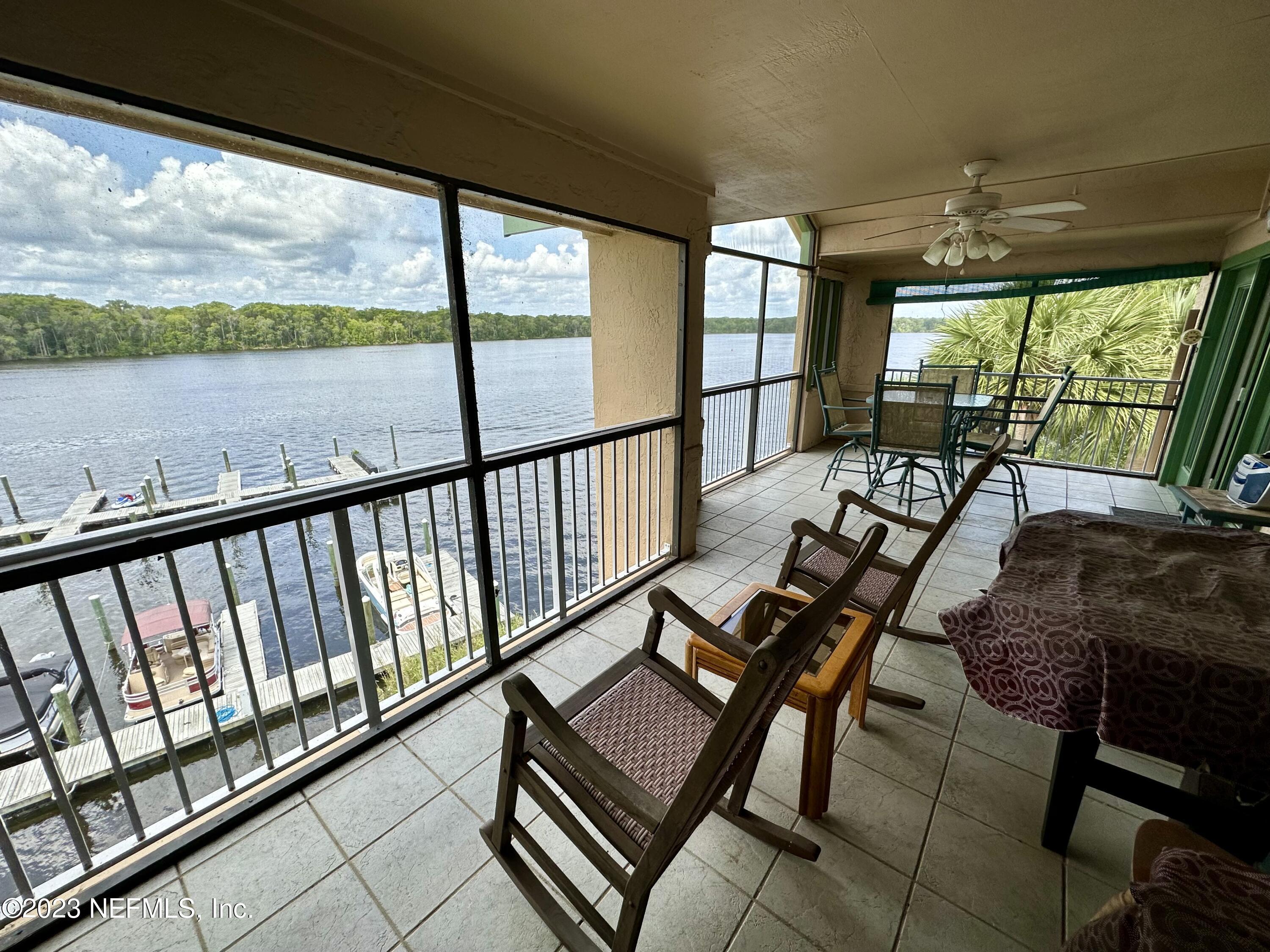99 Broad River Place, Unit 1301 Welaka, FL 32193 - Photo 49 of 50 a view of a balcony with furniture and wooden floor