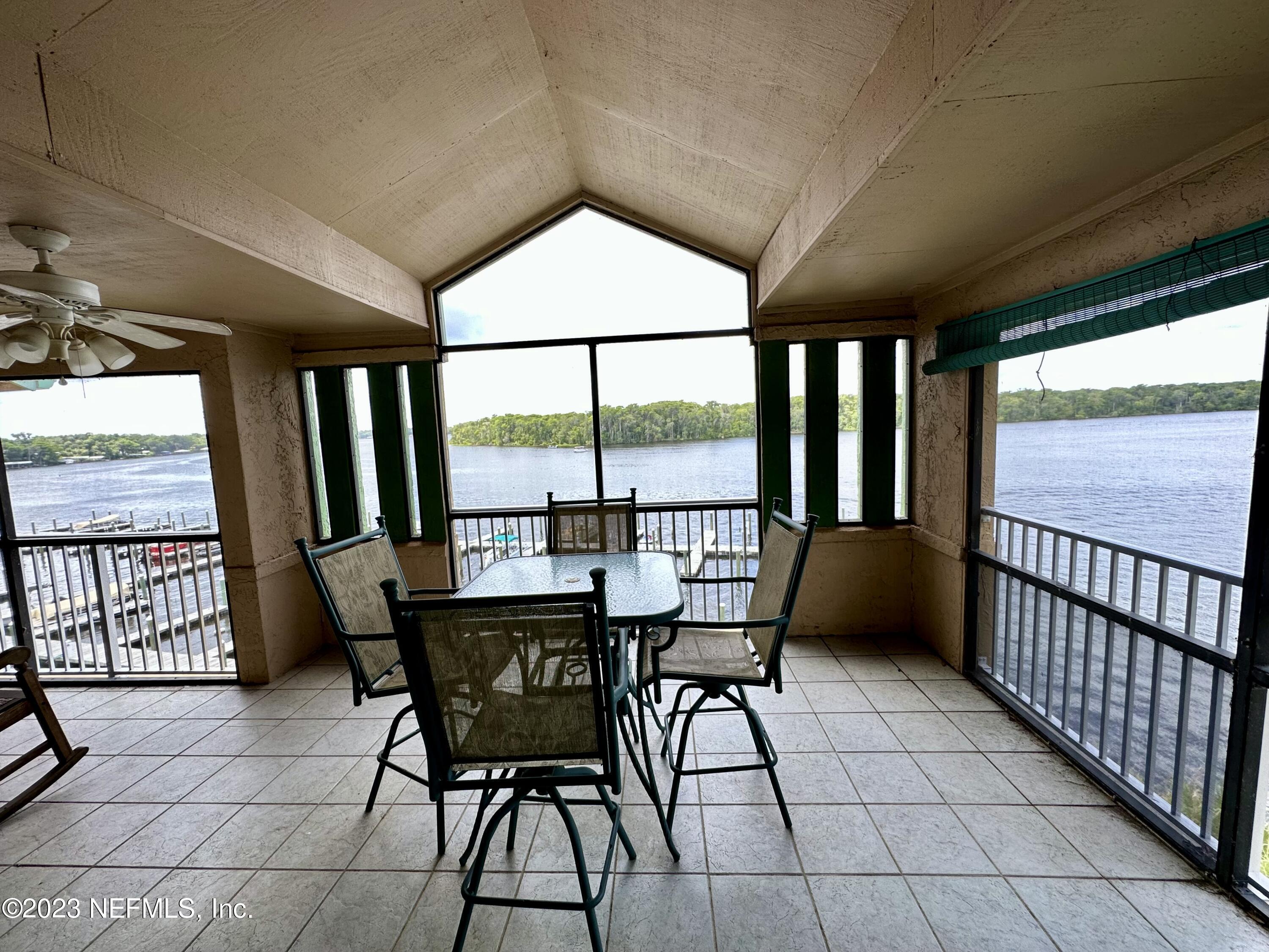 99 Broad River Place, Unit 1301 Welaka, FL 32193 - Photo 50 of 50 a view of a dining room with furniture large windows and wooden floor