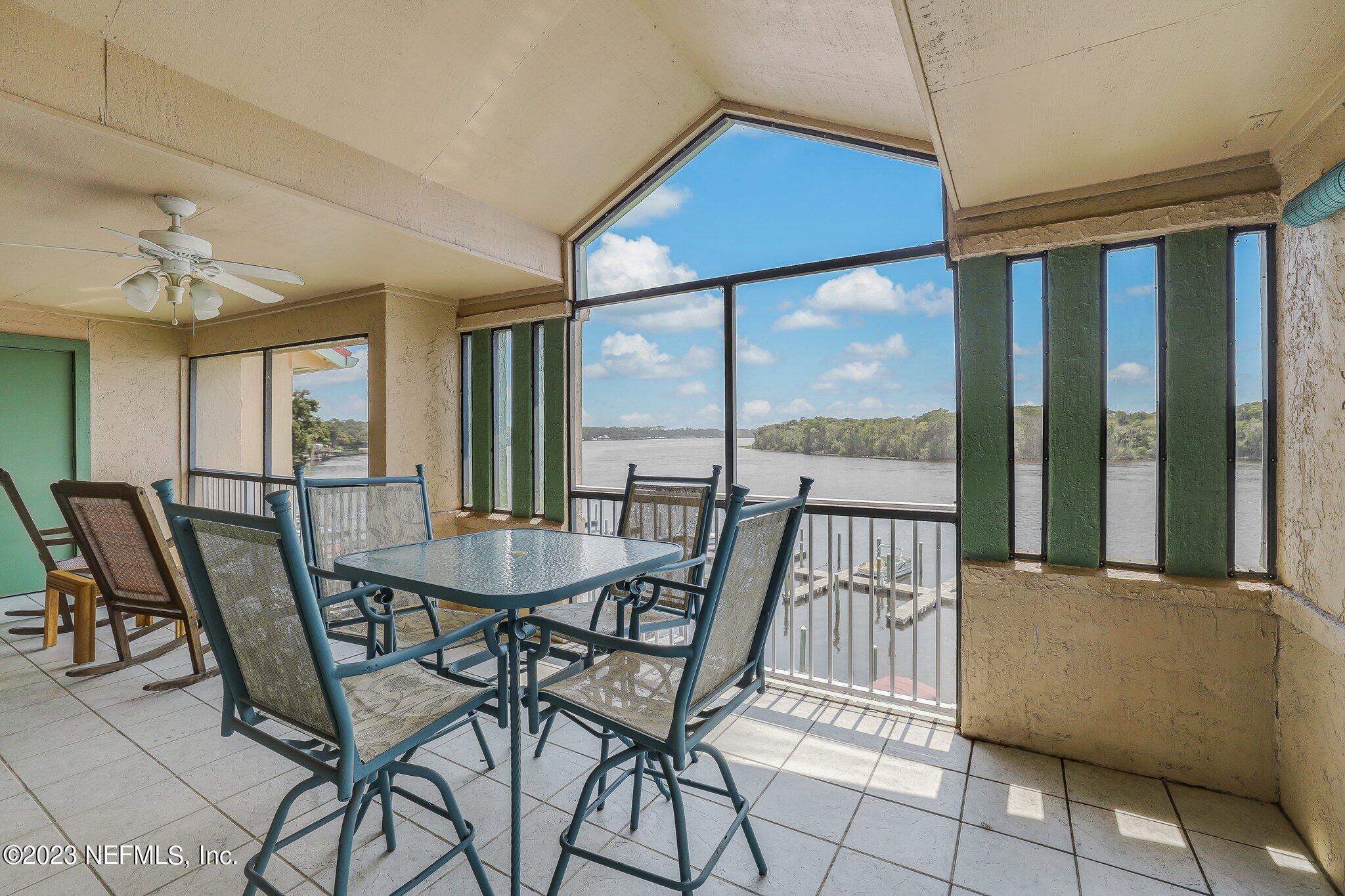 99 Broad River Place, Unit 1301 Welaka, FL 32193 - Photo 5 of 50 a view of a dining room with furniture large windows and wooden floor