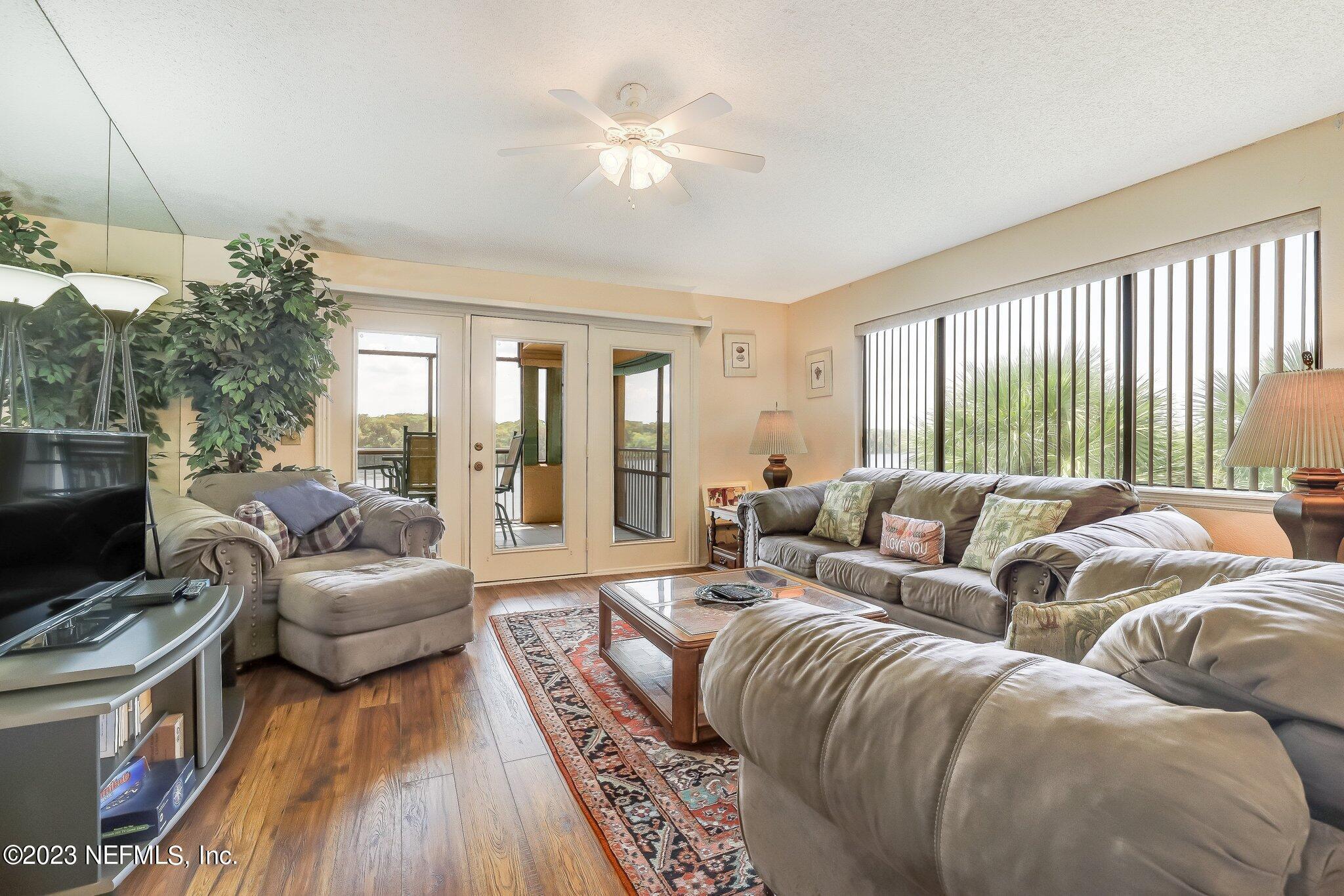 99 Broad River Place, Unit 1301 Welaka, FL 32193 - Photo 8 of 50 a living room with furniture and a flat screen tv