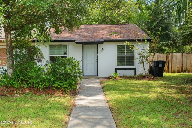 a front view of a house with a garden and porch