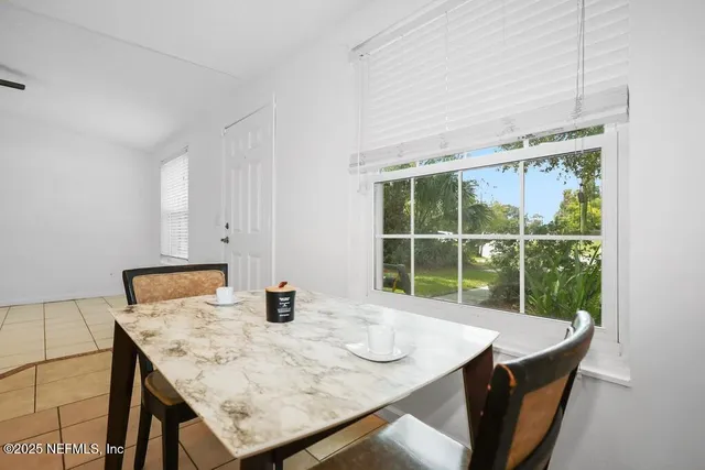 a dining room with a table and chairs