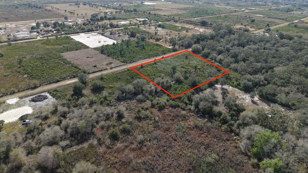 18185 Northwest 252nd Street Okeechobee, FL 34972 - Photo 3 of 19 an aerial view of a house with a yard and lake view