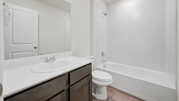 a bathroom with a sink a toilet and bathtub