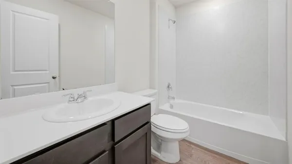 a bathroom with a sink a toilet and bathtub
