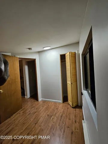 a view of hallway with wooden floor