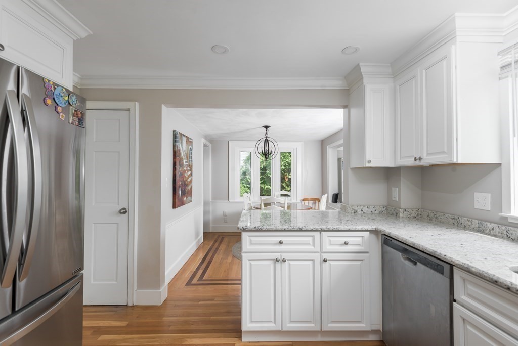 18 Chesterfield Road Milton, MA 02186 - Photo 13 of 38 a kitchen with white cabinets and a refrigerator