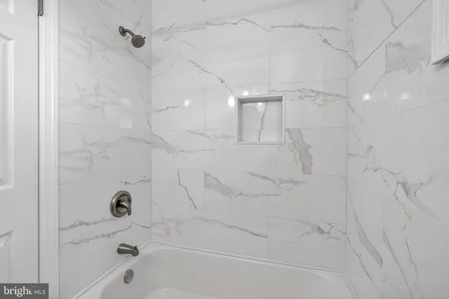 a bathroom with a bathtub and shower