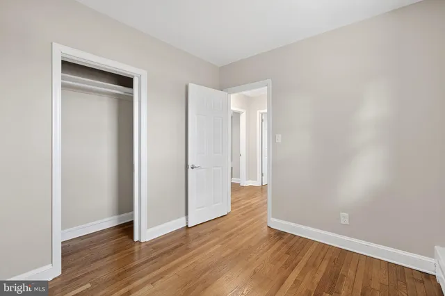 a view of an empty room and wooden floor