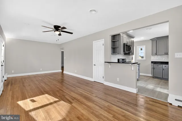 a view of a kitchen with wooden floor and a kitchen