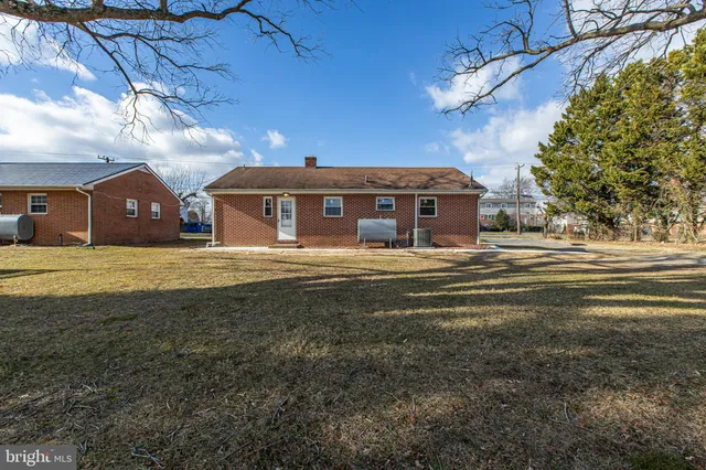 a view of a big house with a big yard