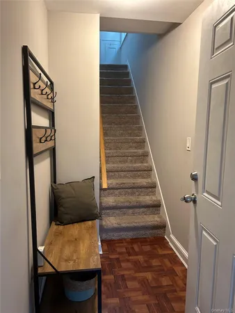 a view of entryway and hall with wooden floor