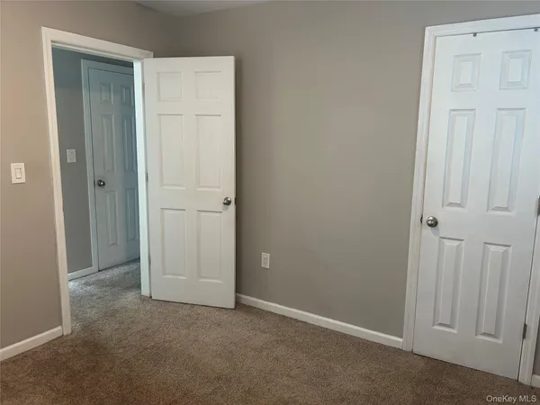 an empty room with closet area