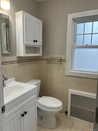 a bathroom with a sink a toilet and mirror