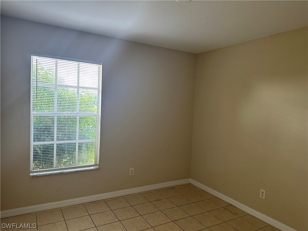 4106 24th Street Southwest Lehigh Acres, FL 33976 - Photo 11 of 15 an empty room with a window