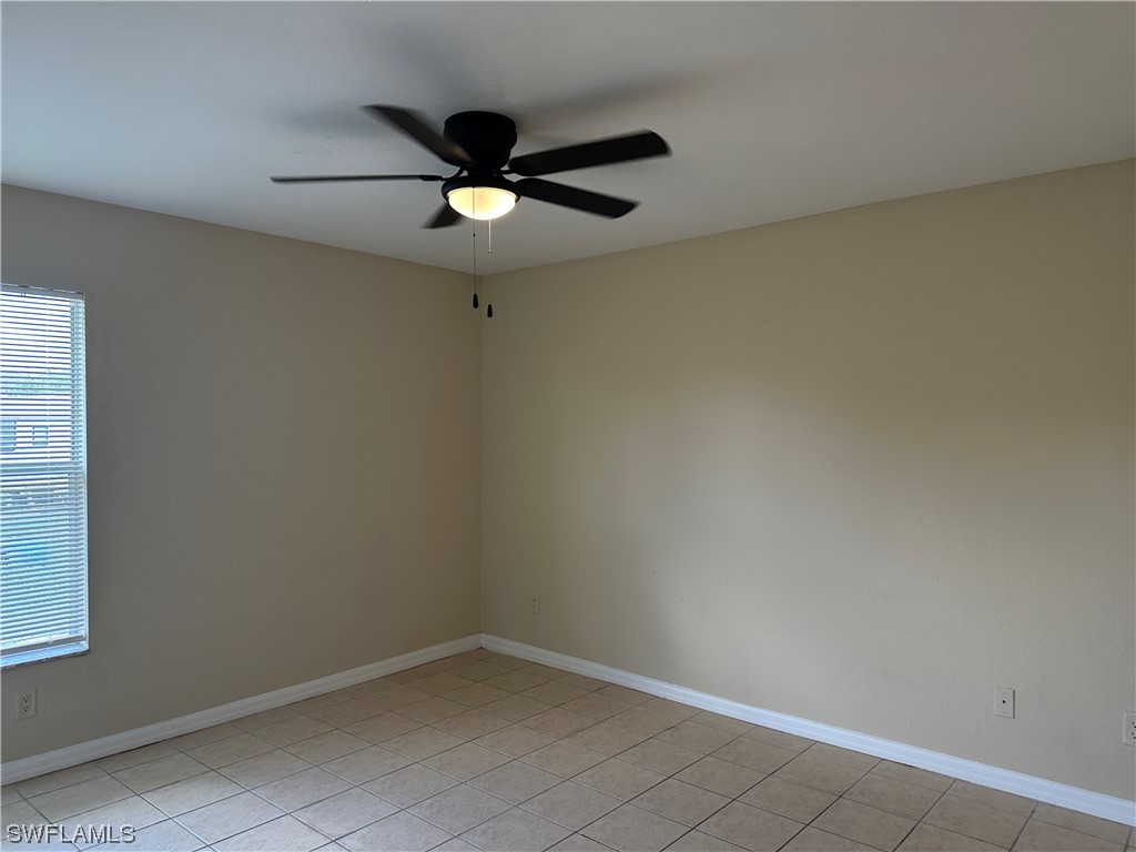4106 24th Street Southwest Lehigh Acres, FL 33976 - Photo 13 of 15 an empty room with a window and a fan