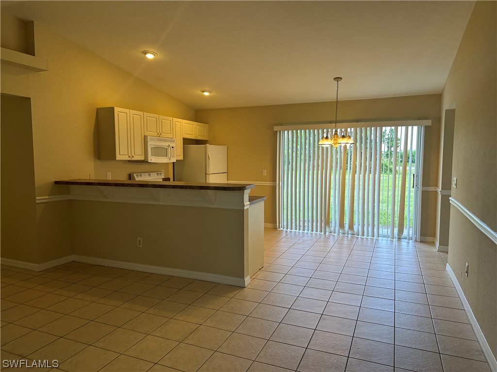 4106 24th Street Southwest Lehigh Acres, FL 33976 - Photo 3 of 15 a kitchen with stainless steel appliances a sink stove and cabinets